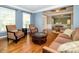 Bright living room with hardwood floors, blue walls, and comfortable seating near the front door at 9212 John Hawks Rd, Cornelius, NC 28031