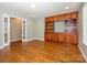 Spacious living room featuring wood floors, custom built-ins, and a doorway to an adjacent room at 9212 John Hawks Rd, Cornelius, NC 28031