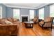 Comfortable living room with a fireplace, hardwood floors, and ample natural light at 9212 John Hawks Rd, Cornelius, NC 28031