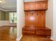 Convenient mudroom featuring built-in storage with a bench and hooks for organization at 9212 John Hawks Rd, Cornelius, NC 28031