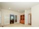Home office featuring neutral carpet, glass doors, and built-in wood shelving at 9212 John Hawks Rd, Cornelius, NC 28031