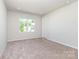 Inviting bedroom with soft carpeting, a large window, and abundant natural light, ready for your personal touch at 9221 Widden Way, Charlotte, NC 28269