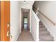 Bright entryway features neutral walls, hardwood flooring, a staircase, and a clear view to the backyard at 9221 Widden Way, Charlotte, NC 28269