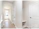 Bright foyer features sleek, light-colored floors and walls with a built in bench and coat rack at 9221 Widden Way, Charlotte, NC 28269
