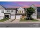 Charming townhomes with attached garages and manicured lawns create an inviting curb appeal at 9221 Widden Way, Charlotte, NC 28269