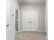 Hallway with carpet and white doors, accented by neutral walls and clean lines throughout at 9221 Widden Way, Charlotte, NC 28269