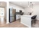 Charming kitchen featuring stainless steel appliances, a stylish island with barstool seating, and hardwood floors at 9221 Widden Way, Charlotte, NC 28269