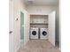 Convenient laundry room with side-by-side washer and dryer, upper cabinets, and easy access for everyday chores at 9221 Widden Way, Charlotte, NC 28269
