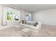 Inviting living area features a comfortable sofa, large windows, and plush carpet, perfect for relaxation at 9221 Widden Way, Charlotte, NC 28269