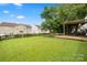 Beautiful backyard with a well-maintained lawn, pergola, and a fence ensuring privacy, ideal for relaxation and outdoor activities at 9429 Coast Laurel Nw Ave, Concord, NC 28027