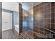 Modern bathroom featuring a tiled shower with a glass wall and bench at 9429 Coast Laurel Nw Ave, Concord, NC 28027