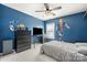 Large bright bedroom with blue walls, large window, ceiling fan, and plush carpet at 9429 Coast Laurel Nw Ave, Concord, NC 28027