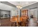 Elegant dining room with hardwood floors, wooden furniture, chandelier, and views into office and living room at 9429 Coast Laurel Nw Ave, Concord, NC 28027