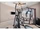 Bright gym with large window, weights, equipment, and ceiling fan at 9429 Coast Laurel Nw Ave, Concord, NC 28027