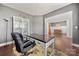 Cozy home office with a large desk, chair, and built-in shelving, opening up to the adjacent dining area at 9429 Coast Laurel Nw Ave, Concord, NC 28027