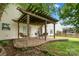 Inviting outdoor patio with a wooden pergola, a dining set, and a swing overlooking a lush, green yard at 9429 Coast Laurel Nw Ave, Concord, NC 28027