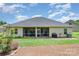 Backyard featuring a screened-in porch, patio area, and grassy lawn at 101 Harvest Farm Ct, Mount Holly, NC 28120