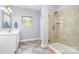 Bathroom with glass shower, modern fixtures, neutral tile and white vanity at 101 Harvest Farm Ct, Mount Holly, NC 28120