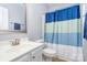 Bright bathroom featuring a large vanity, mirror, and tub at 101 Harvest Farm Ct, Mount Holly, NC 28120