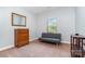 Neutral bedroom with vintage dresser, futon, and carpet flooring at 101 Harvest Farm Ct, Mount Holly, NC 28120