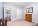 Bedroom featuring neutral walls, carpet, double doors, and vintage dresser at 101 Harvest Farm Ct, Mount Holly, NC 28120