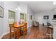 Cozy dining area with wood table, chair set, and natural light from the windows, adjacent to the living room at 101 Harvest Farm Ct, Mount Holly, NC 28120