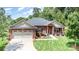 Charming single-story brick home with a two-car garage, manicured lawn, and inviting front porch at 101 Harvest Farm Ct, Mount Holly, NC 28120