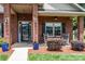 Inviting front porch with rocking chairs, elegant planters, and a 'Welcome' sign at 101 Harvest Farm Ct, Mount Holly, NC 28120