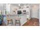 Stylish kitchen bar with granite countertops, white cabinets, and seating for casual dining at 101 Harvest Farm Ct, Mount Holly, NC 28120