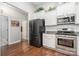 Modern kitchen showcasing stainless steel appliances, white cabinets, and granite countertops at 101 Harvest Farm Ct, Mount Holly, NC 28120
