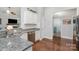 Kitchen featuring granite countertops, stainless steel dishwasher, and wood floors at 101 Harvest Farm Ct, Mount Holly, NC 28120