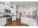 Well-equipped kitchen with stainless steel appliances, granite counters, and white cabinets at 101 Harvest Farm Ct, Mount Holly, NC 28120