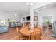 Open-concept living and dining area with hardwood floors, neutral paint, and lots of natural light at 101 Harvest Farm Ct, Mount Holly, NC 28120