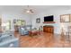 Spacious living room with hardwood floors, comfortable seating, a ceiling fan, and natural light at 101 Harvest Farm Ct, Mount Holly, NC 28120