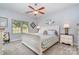 Bedroom with neutral tones, large window, ceiling fan, and comfortable furnishings at 101 Harvest Farm Ct, Mount Holly, NC 28120