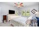 Bright bedroom featuring a ceiling fan, large window for natural light, and simple decor at 101 Harvest Farm Ct, Mount Holly, NC 28120
