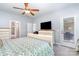 Bedroom with a ceiling fan, ensuite bathroom entrance, and exterior door at 101 Harvest Farm Ct, Mount Holly, NC 28120