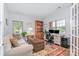 Bright home office with a sofa, bookcase, computer desk, and large windows for natural light at 101 Harvest Farm Ct, Mount Holly, NC 28120