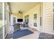 Cozy screened-in porch with comfortable seating, ceiling fan, and backyard views at 101 Harvest Farm Ct, Mount Holly, NC 28120