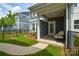 Cozy covered patio with string lights, a privacy screen, and comfortable seating for outdoor relaxation at 10209 Mamillion Dr, Huntersville, NC 28078