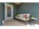 Relaxing covered patio featuring comfortable couch and outdoor decor with stylish lighting at 10209 Mamillion Dr, Huntersville, NC 28078