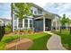 Inviting backyard featuring a covered patio and landscaped garden with ornamental trees at 10209 Mamillion Dr, Huntersville, NC 28078
