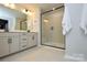 Modern bathroom featuring a glass shower and double vanity with sleek black hardware at 10209 Mamillion Dr, Huntersville, NC 28078