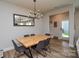 Modern dining room featuring hardwood floors, a stylish chandelier, and a spacious table at 10209 Mamillion Dr, Huntersville, NC 28078