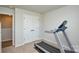 Clean, neutral exercise room with a treadmill and double door closet for storage at 10209 Mamillion Dr, Huntersville, NC 28078