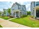 Beautiful two-story home features a well-manicured lawn and a charming front porch with stone accents at 10209 Mamillion Dr, Huntersville, NC 28078