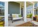 Inviting front porch with a cozy bench, columns, and a view of the well-maintained front yard at 10209 Mamillion Dr, Huntersville, NC 28078