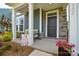 Inviting front porch features stone accents and charming outdoor seating at 10209 Mamillion Dr, Huntersville, NC 28078