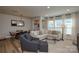 Bright and airy living room with a large sectional sofa, dining area, and hardwood flooring at 10209 Mamillion Dr, Huntersville, NC 28078