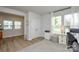 Bright and airy home office featuring hardwood floors, natural light, and a comfortable workspace at 10209 Mamillion Dr, Huntersville, NC 28078
